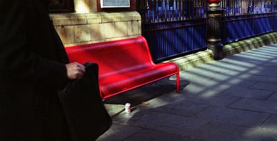 Red bench blue fence