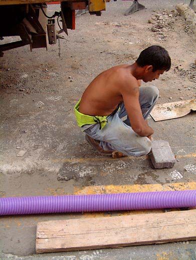 Topless man working on the street